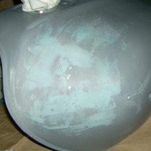 Tank with primer and filler